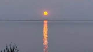 Sun reflected on calm water near Beachcomber RV Park