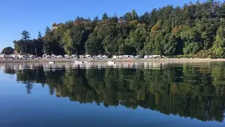 Beachcomber RV Park shoreline reflected in calm water