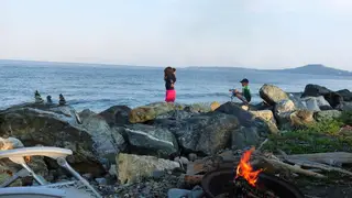 Family campfire beside the beach at Beachcomber RV Park