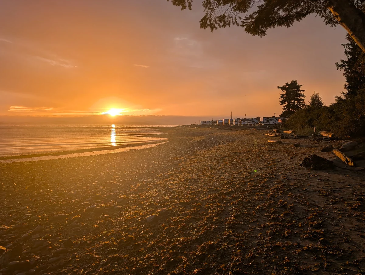 Sunrise over the water from the shoreline at Beachcomber RV Park on September 4, 2026, the morning after a storm